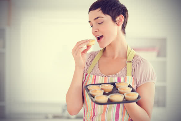 young woman baking cookies at home