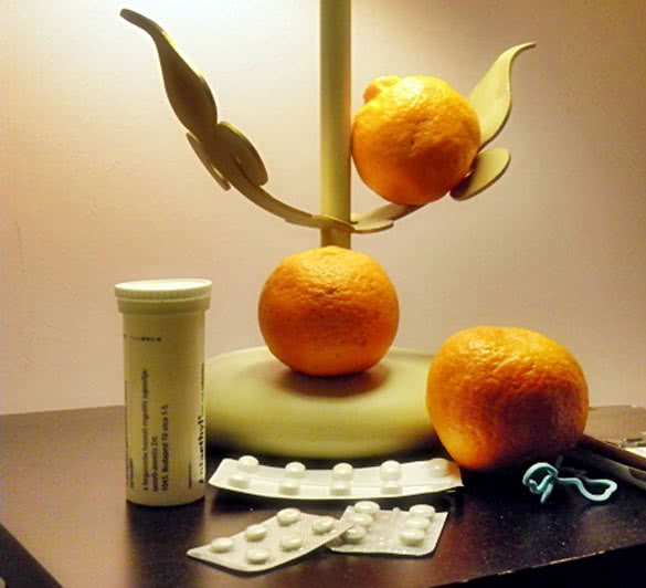 Medications and oranges on the table
