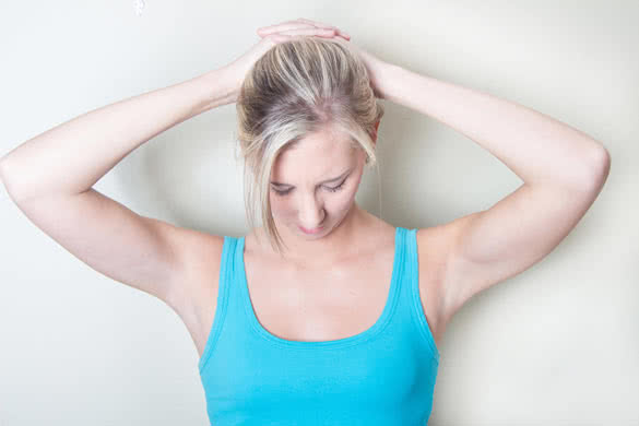 Young woman exercise her neck muscles