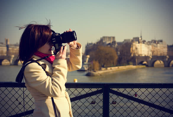 beautiful tourist in paris using her camera