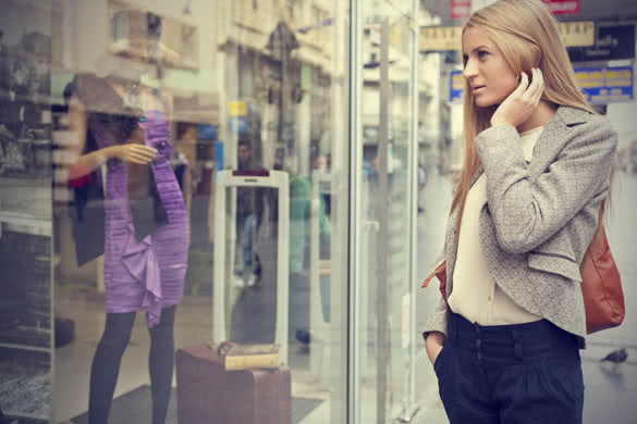 woman in shoping street looking at window