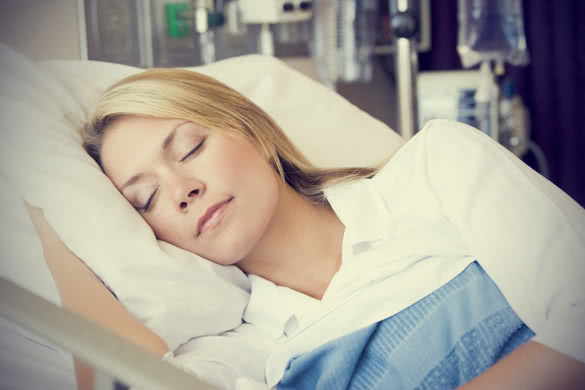 woman sleeping in hospital bed