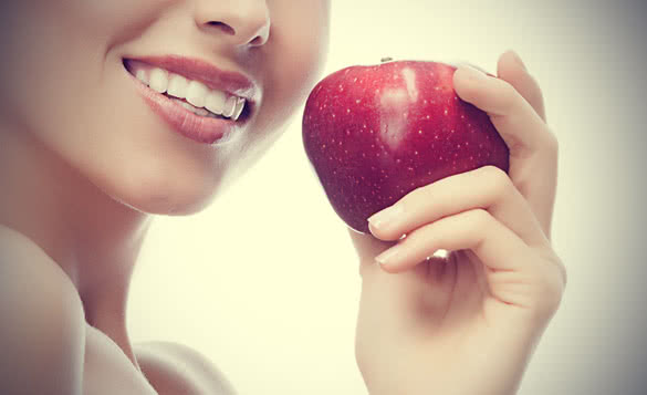 Smiling Woman Holding Red Apple