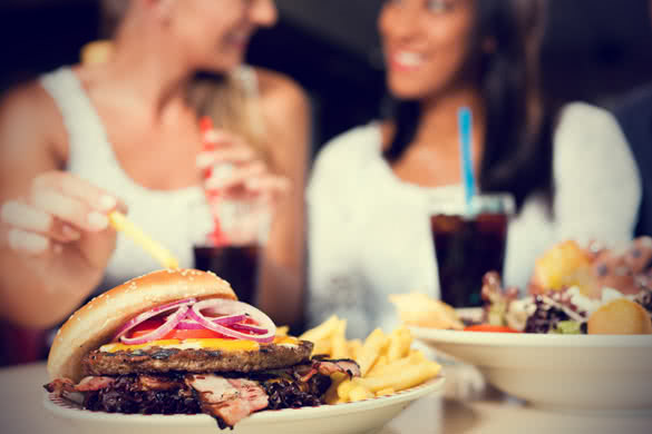 2 Girls eating Fast Food