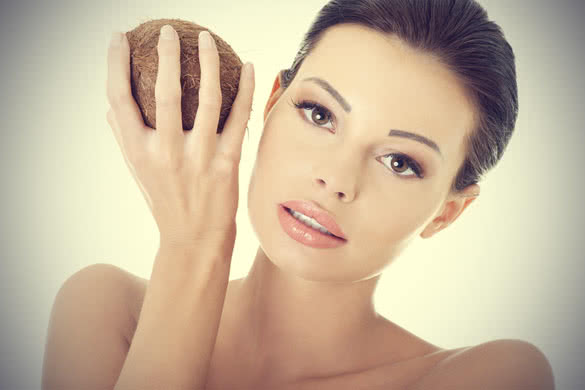 Beautiful woman with coconut in hands