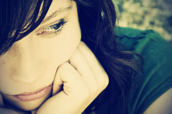 Thoughtful young woman with pensive gesture