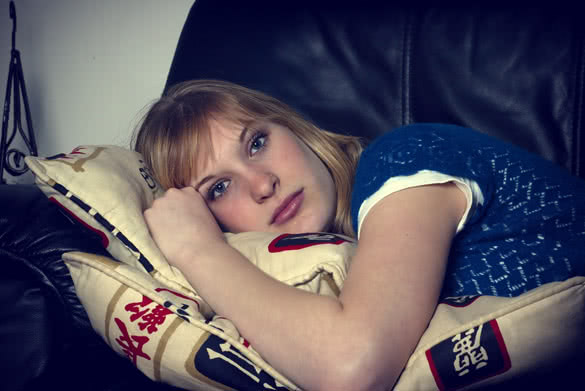 Tired Girl Resting on Sofa