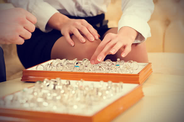 couple choosing wedding rings at a jeweller