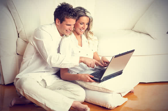 smiling couple with laptop
