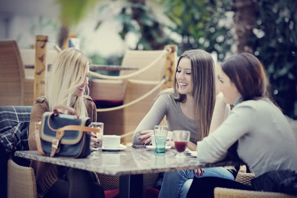 very cute smiling women drinking a coffee