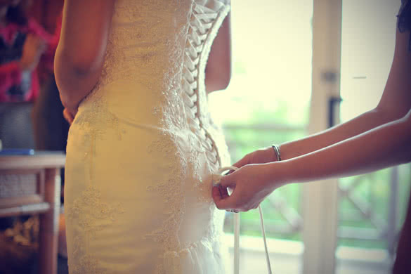 wedding gown being tied up