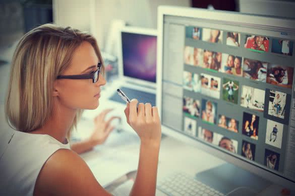 woman in front of big screen computer