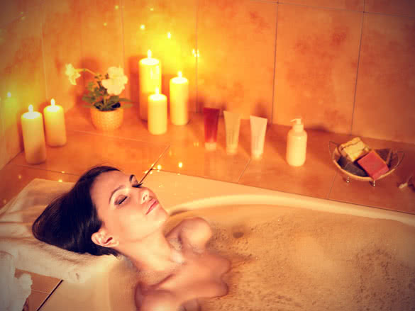 Young woman resting in bubble bath