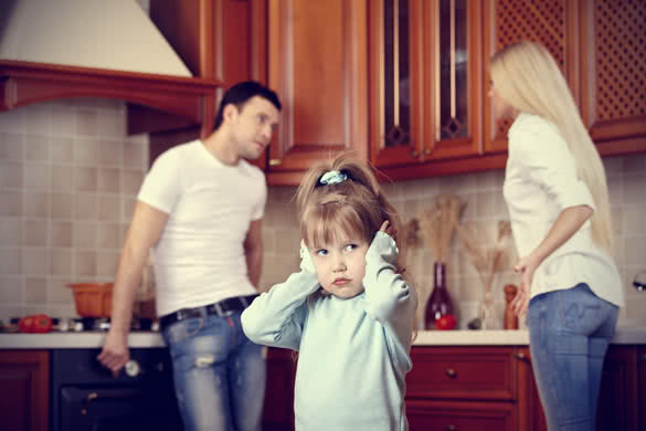 girl in the foreground at quarrel of parents