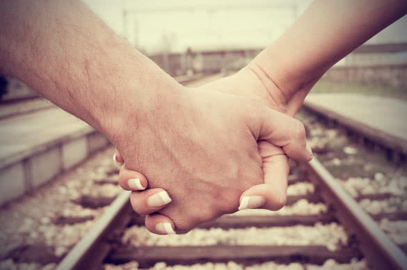 holding hands on railway