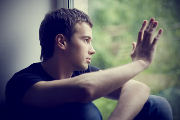 lonely guy looking through window