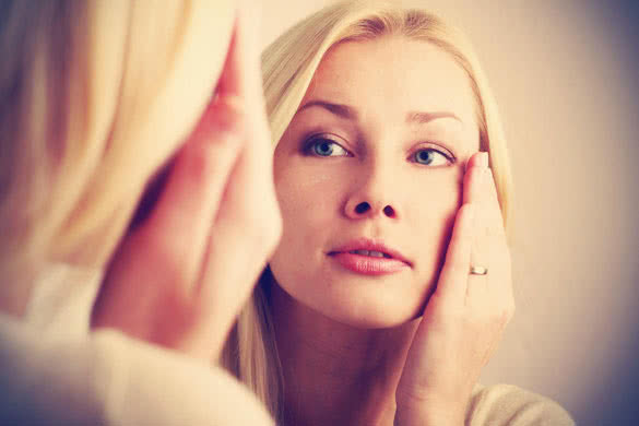 woman in 40s moisturize face skin
