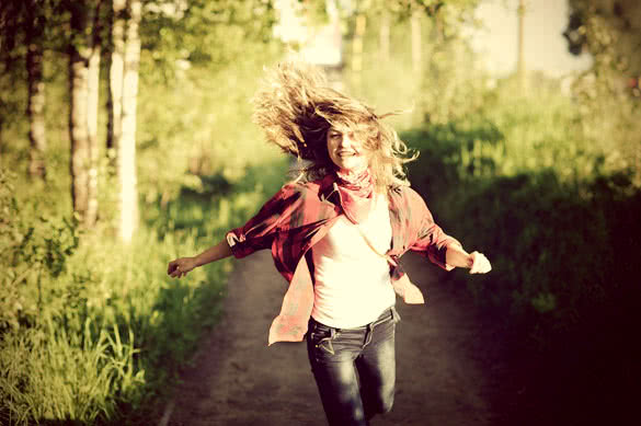 happy teenager girl in red shirt walking