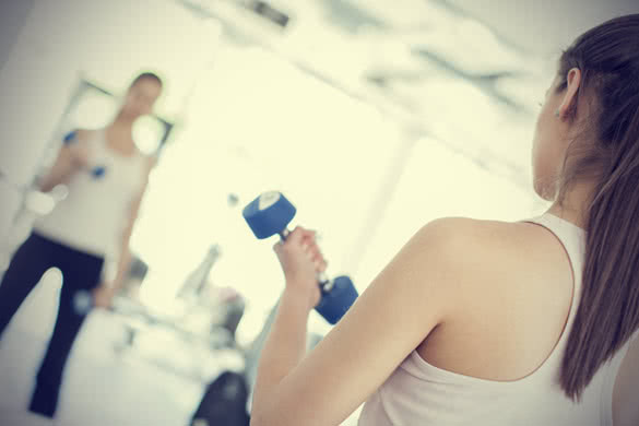 woman working with dumbbells in gym