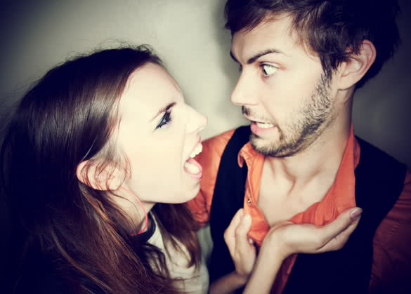 young woman screaming at hapless bearded man