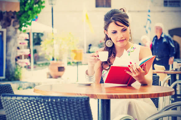 Girl reading book in coffee