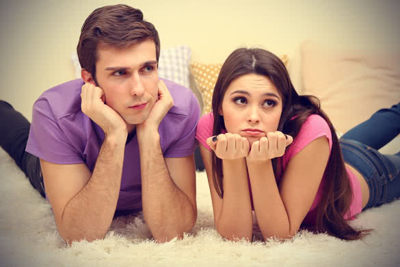 young couple lying on carpet at home
