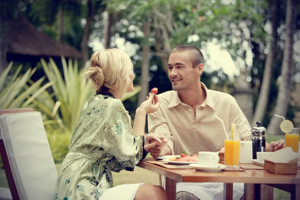 attractive couple having breakfast in a garden