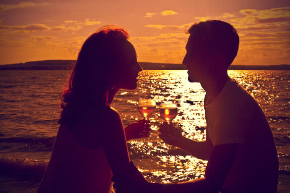 silhouettes of man and woman clinging glasses of champagne