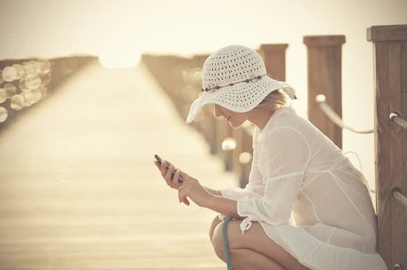 young woman outdoor in summer using cellphone