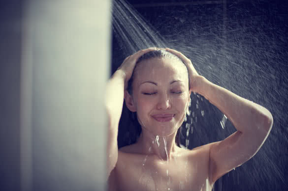Attractive Mixed Female Taking a Shower with hands in hair