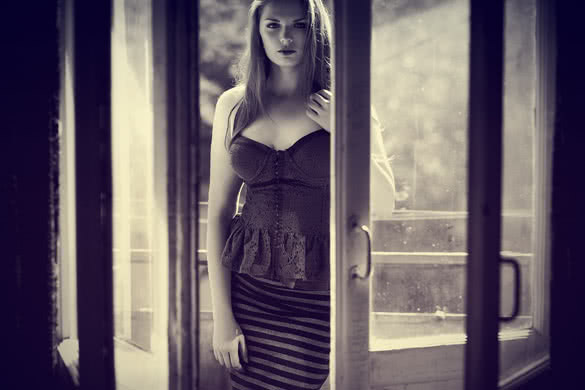 beautiful young woman standing near entrance doors