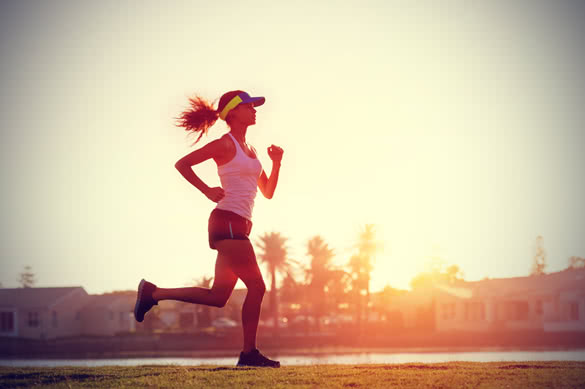 silhouette of a woman athlete running at sunset