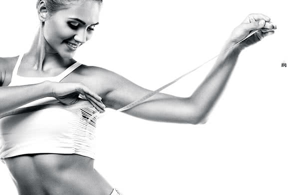 Blak and white Photo of a Girl Measuring Fat