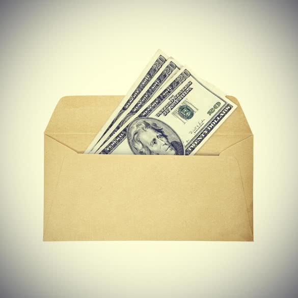 a stack of us dollar twenties currency bills in an open brown paper envelope