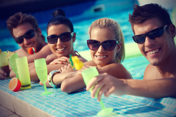 attractive young couples refreshing in swimming pool
