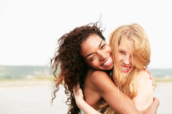 two female friends hugging and smiling