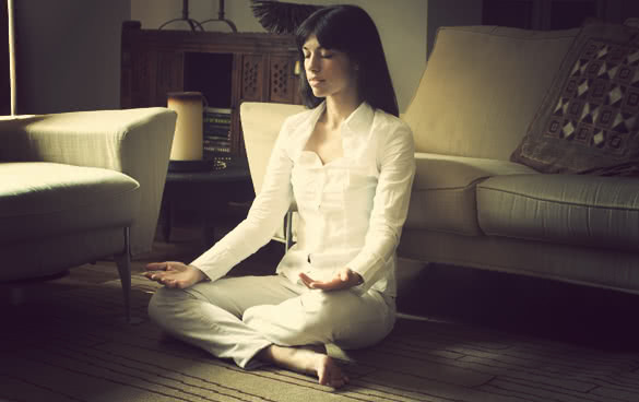 woman meditating in living room