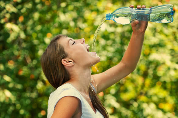 woman drinking big bottle of water