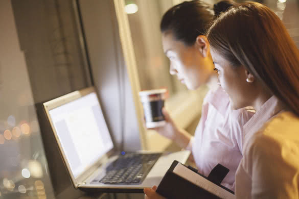 Two young woman working in the office