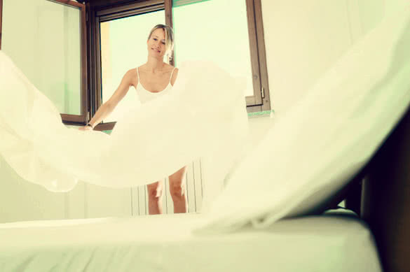 woman changing sheets