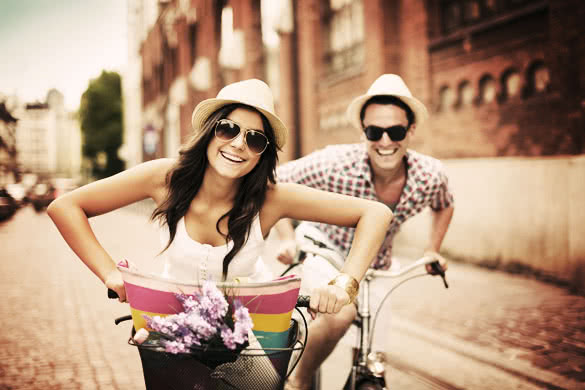 Happy couple cycling in the city