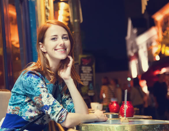 Beautiful redhead women sitting in cafe in Paris