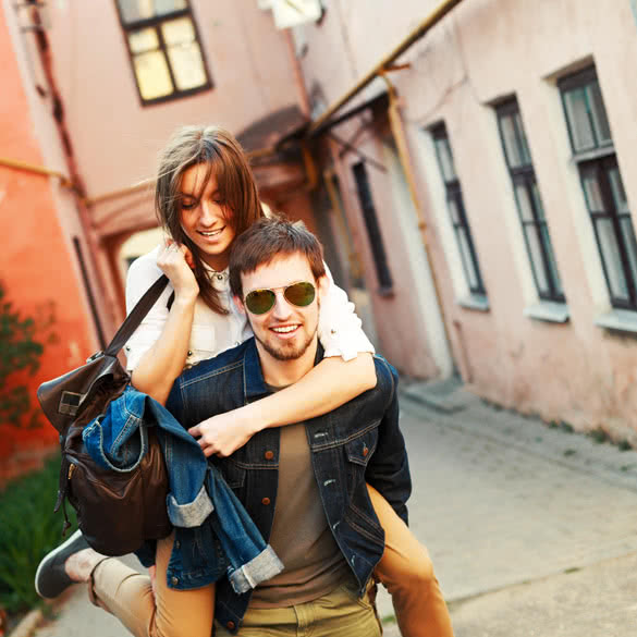 Young beautiful funny couple in love having fun outdoor on the street in summer