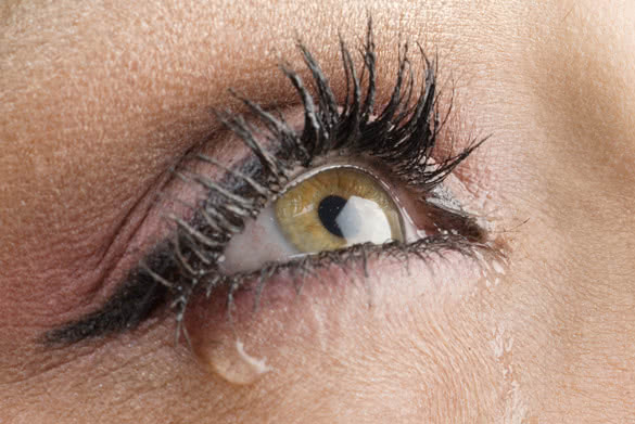 close up on the eyes of a young woman crying