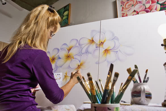 female artist painting on canvas
