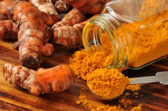 Fresh turmeric root and ground spice