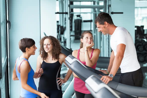 Attractive Man at Gym with Three Women