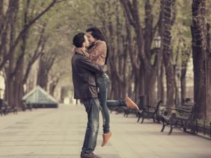 Couple kissing at alley in city