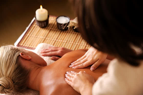 Masseur doing massaging backbone of woman in spa salon