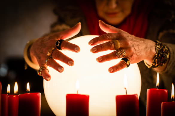 Woman looking into their crystal ball during a Seance
